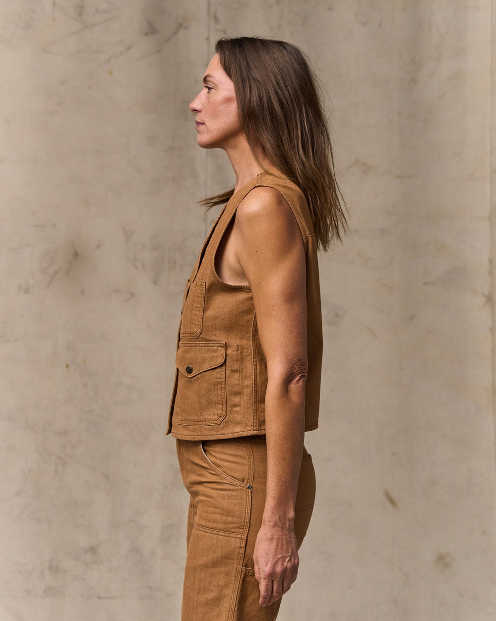 image of a model wearing Filson's Women's Archive Cruiser Vest - Harvest Tan