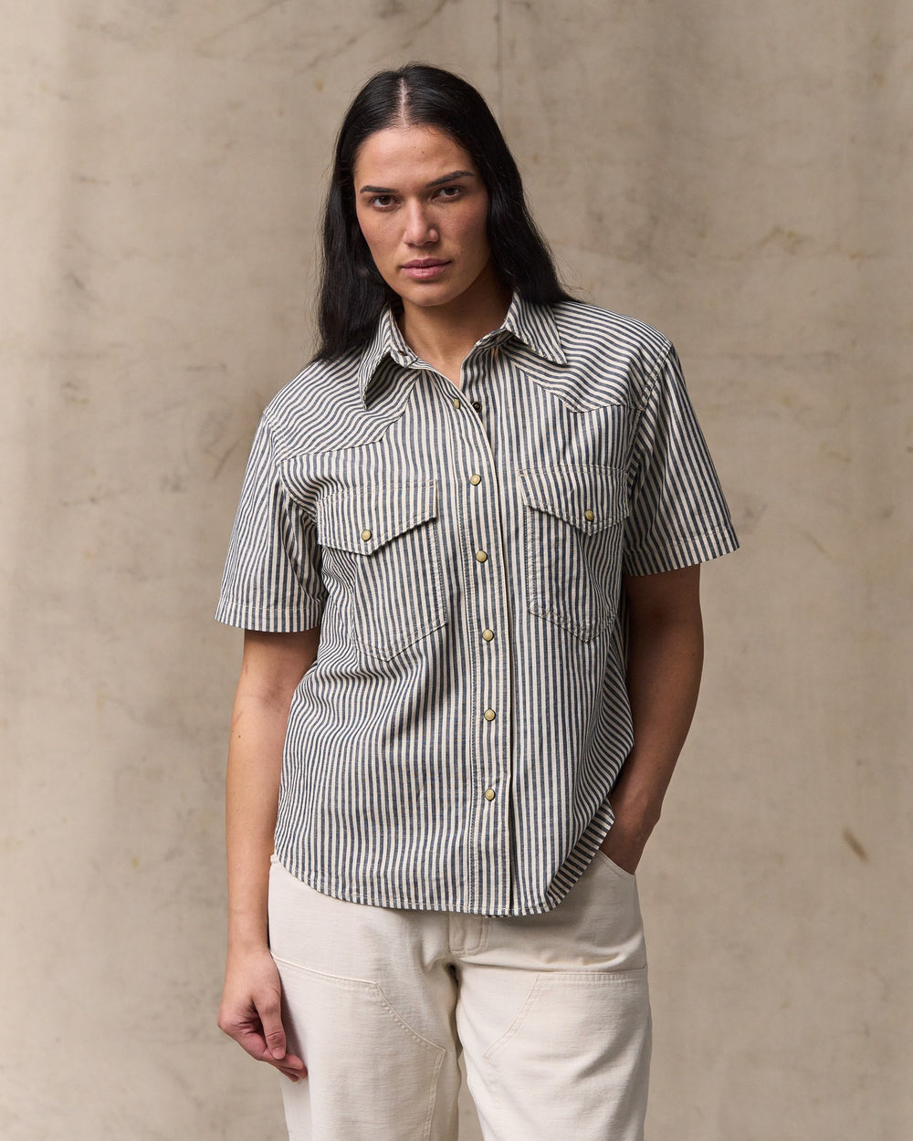 image of a model wearing Filson's Women's Short Sleeve Chambray Western Shirt - Indigo / Natural