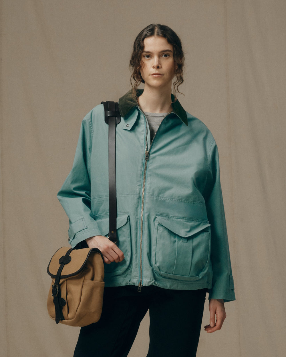 image of a model wearing Filson's Women's Cover Cloth Raincoat - Balsam Green