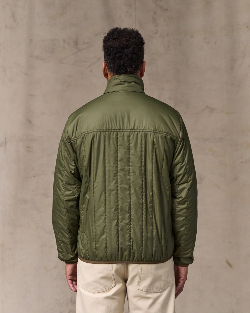 image of a model wearing Filson's Ultralight Jacket - Dark Olive Drab