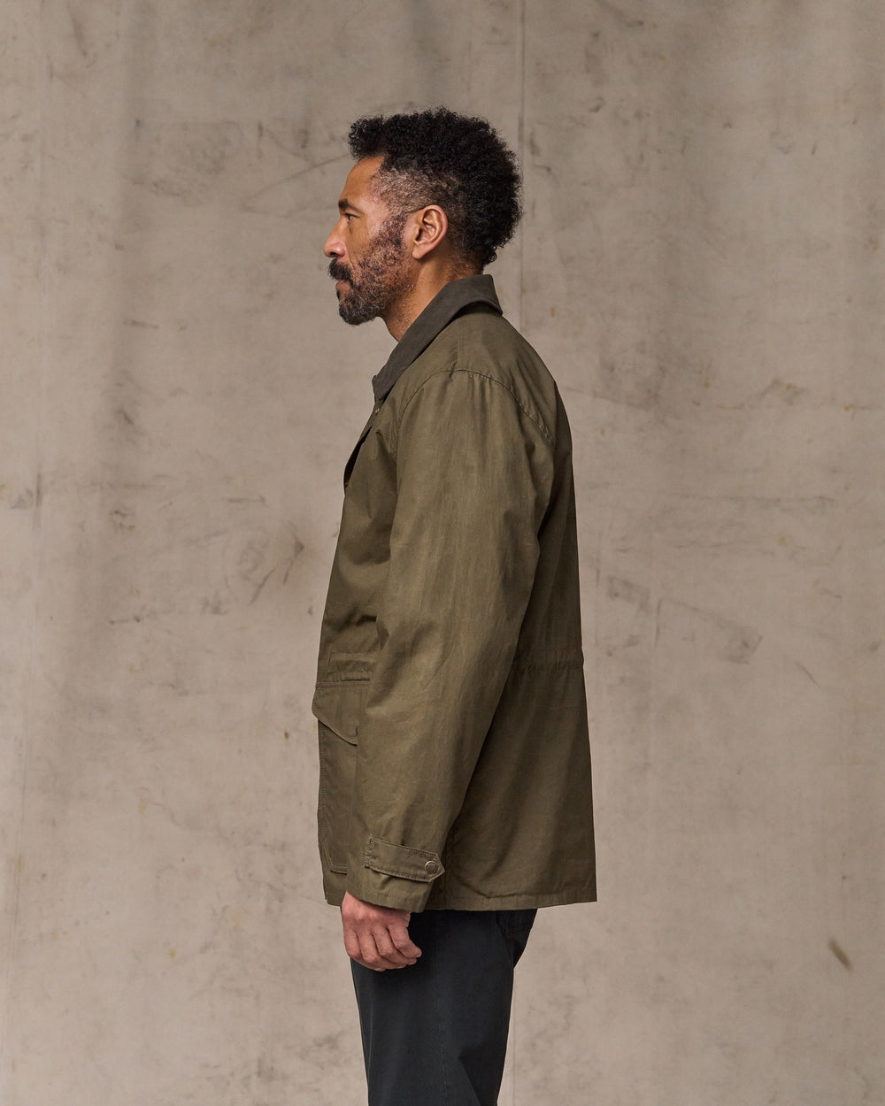 image of a model wearing Filson's Dry Wax Mile Marker Coat - Burnt Olive