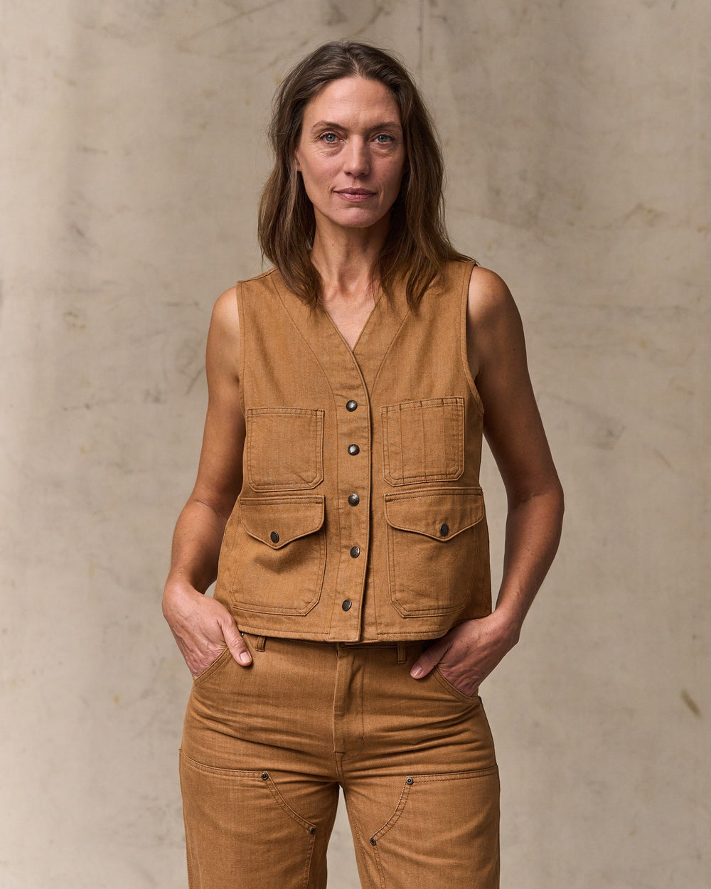 image of a model wearing Filson's Women's Archive Cruiser Vest - Harvest Tan