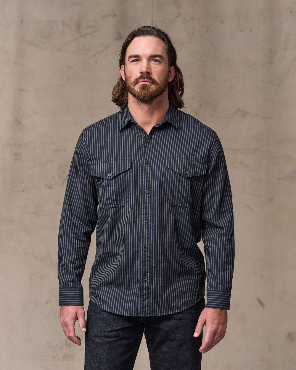 image of a model wearing Filson's Lightweight Alaskan Guide Shirt - Indigo / Ticking Stripe