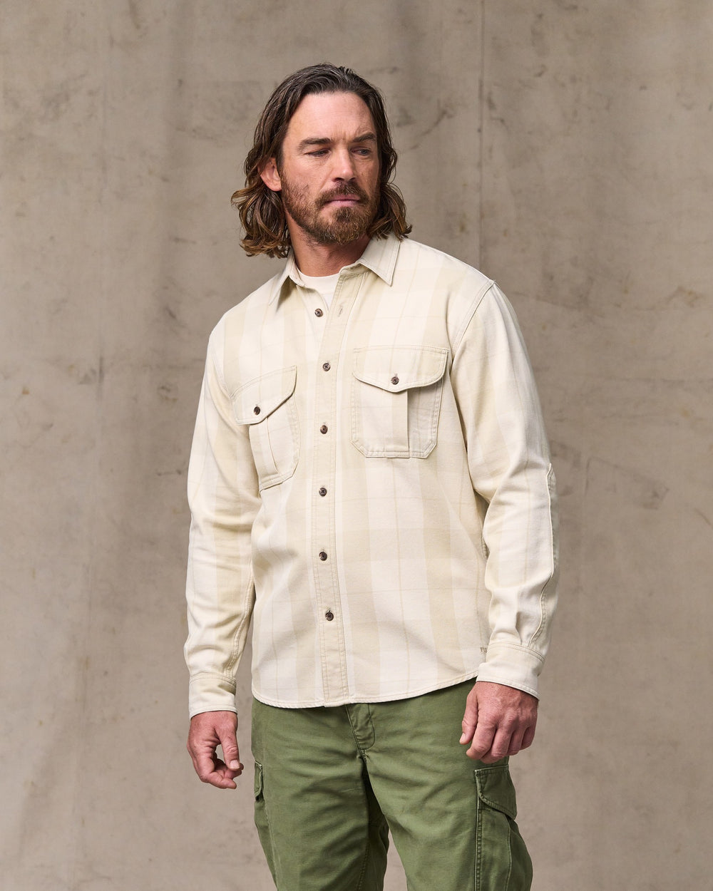 image of a model wearing Filson's Vintage Wash Alaskan Guide Shirt - Sand / Stone Plaid