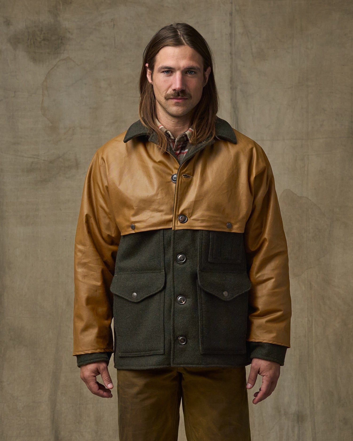 image of a model wearing Filson's Mackinaw Wool Caped Cruiser Jacket - Peat Black / Dark Tan|Model is 5'10" wearing a size medium