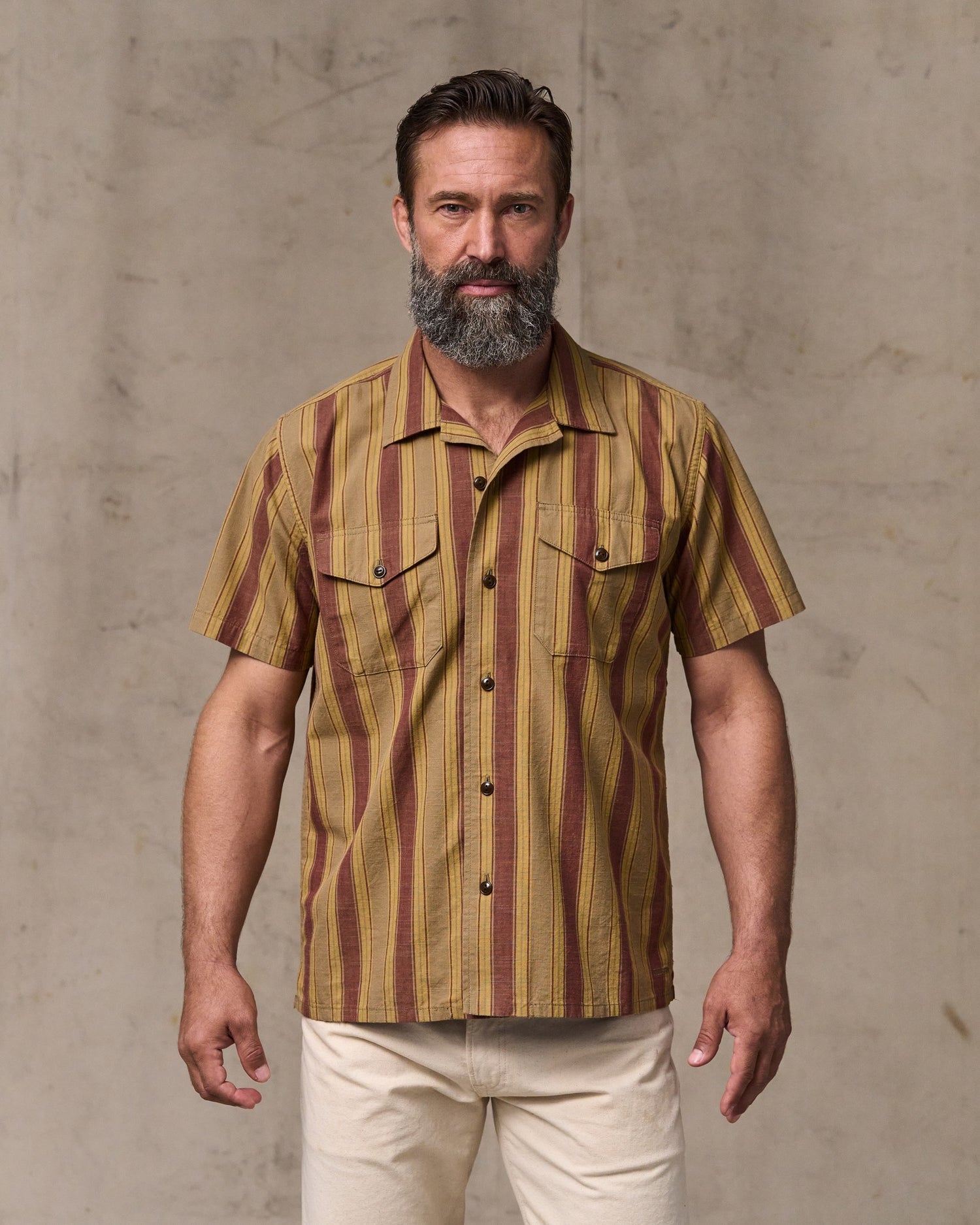 image of a model wearing Filson's Chambray Camp Shirt - Brick / Tan|Model is 6'1" wearing a size medium