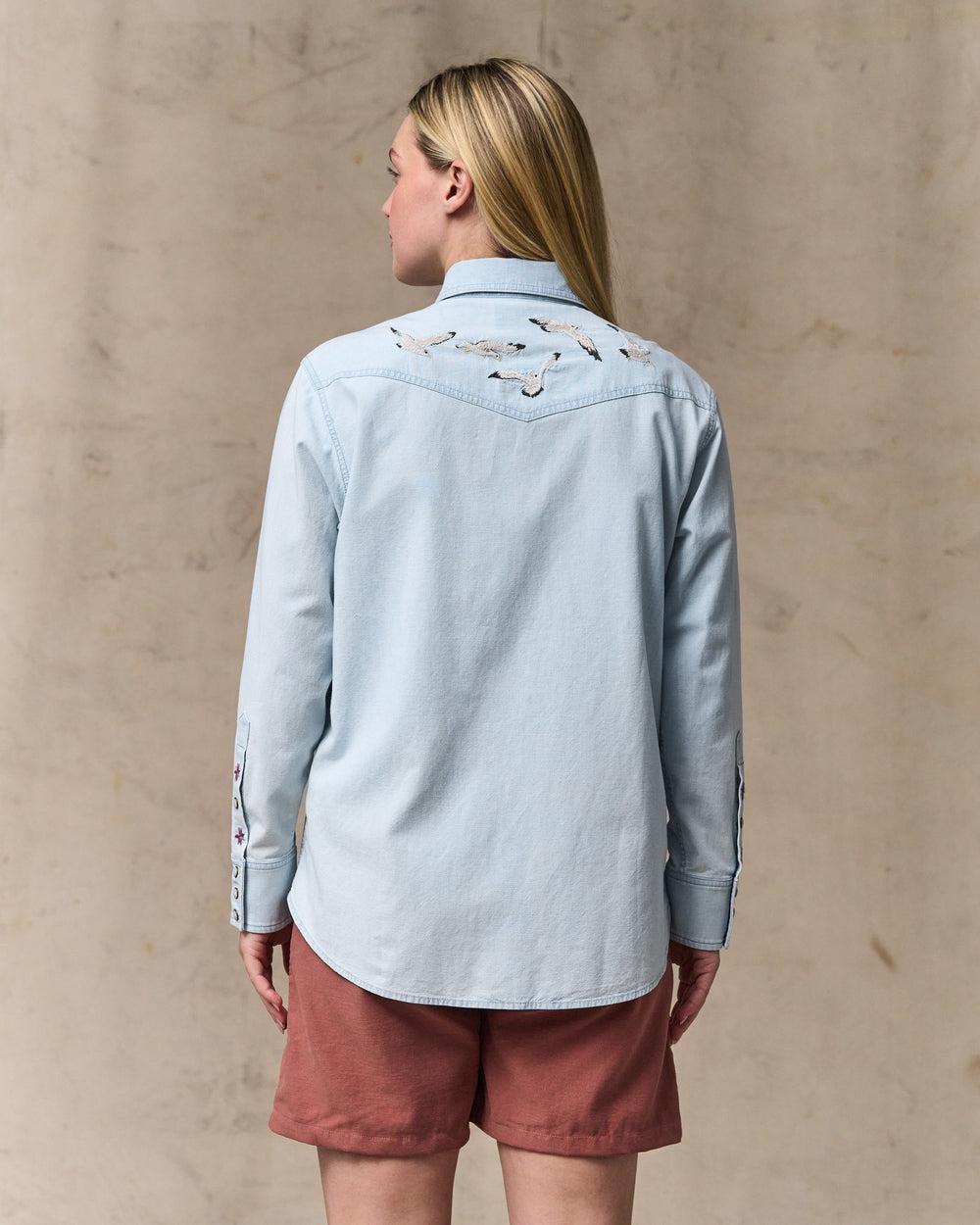 image of a model wearing Filson's Women's Embroidered Western Shirt - Light Indigo