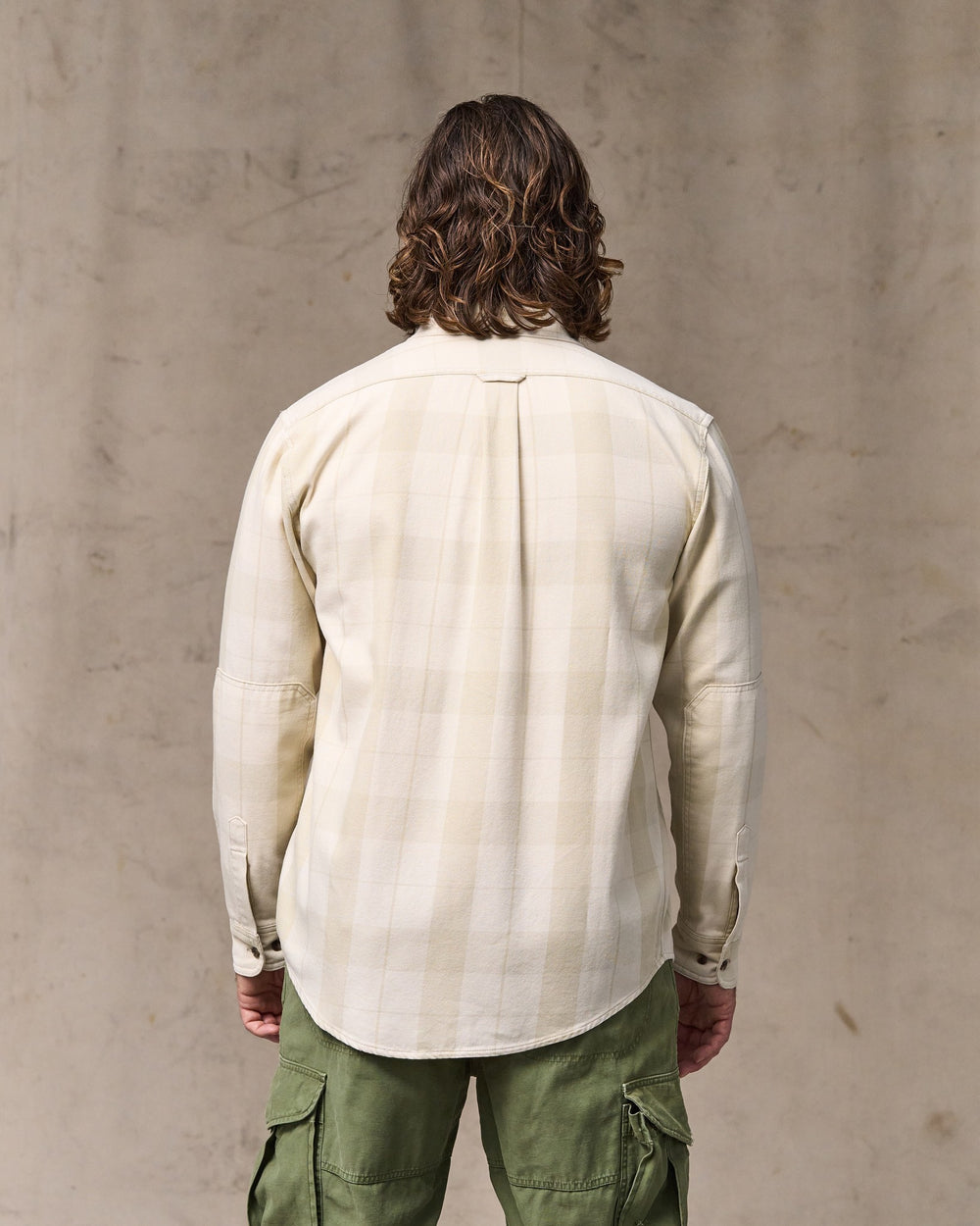 image of a model wearing Filson's Vintage Wash Alaskan Guide Shirt - Sand / Stone Plaid