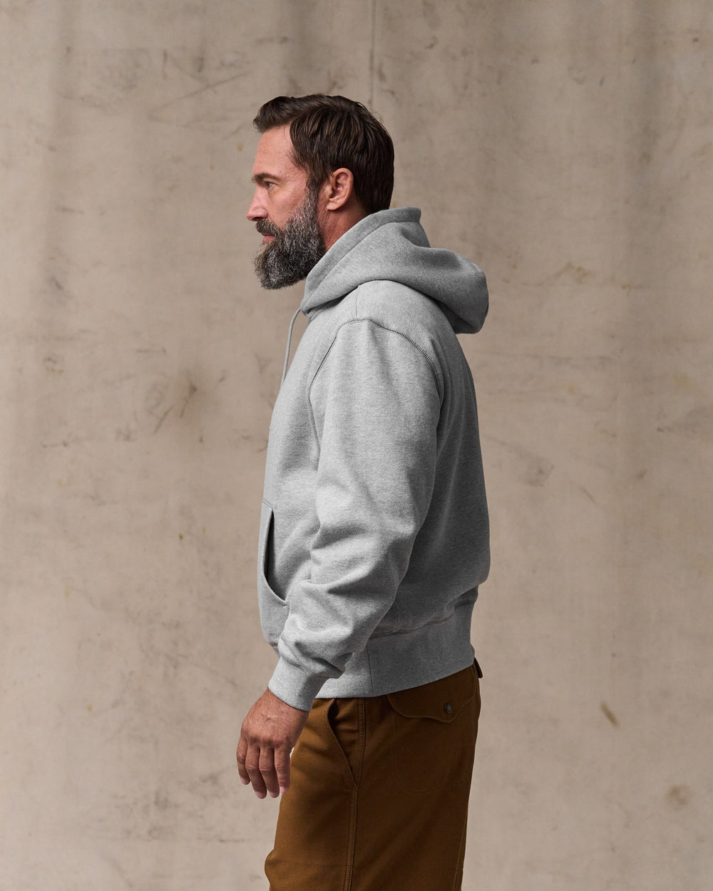 image of a model wearing Filson's 14-oz. Heritage Fleece Hoodie - Gray Heather