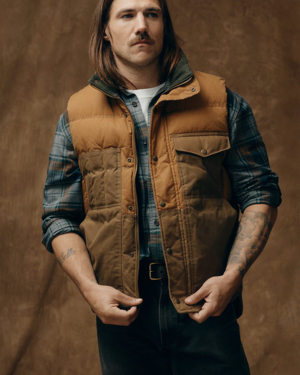 image of a model wearing Filson's Down Cruiser Vest - Dark Tan