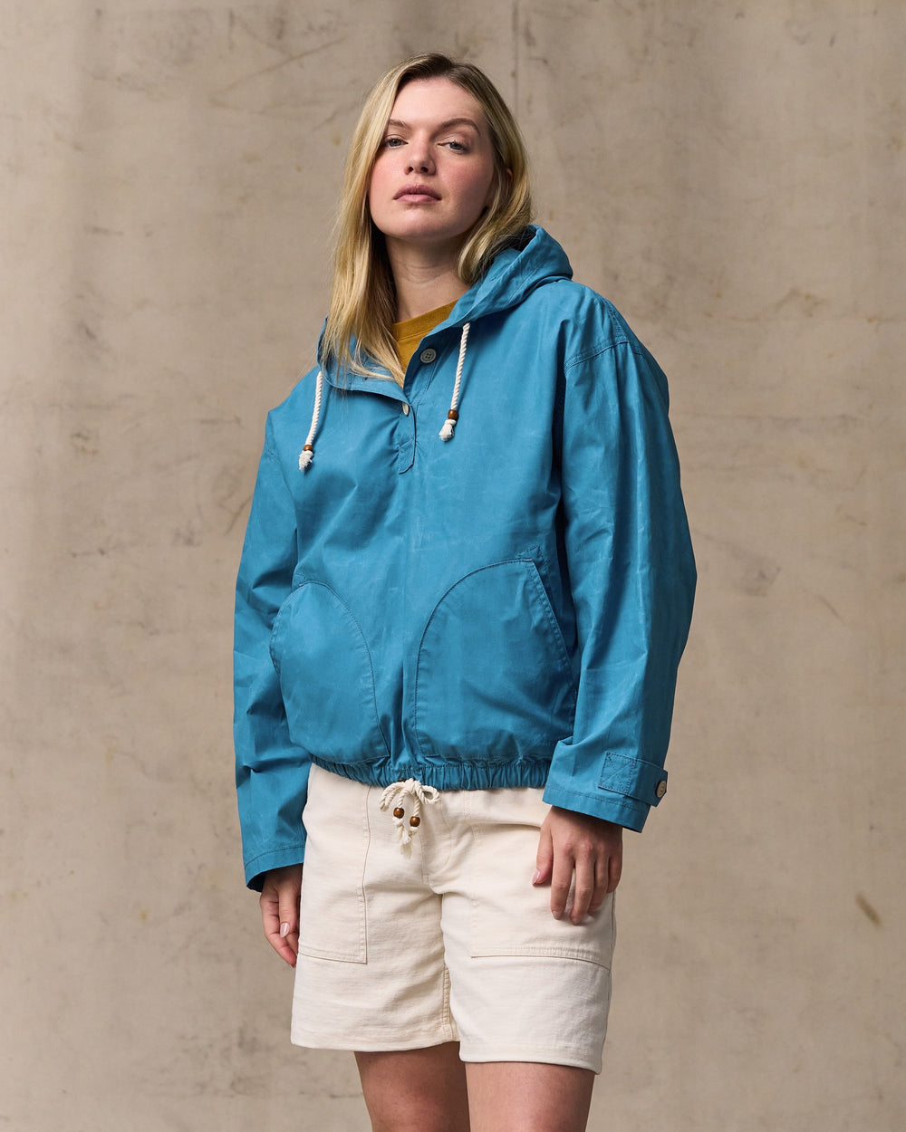 image of a model wearing Filson's Women's Dry Wax Hooded Popover - Marine Blue
