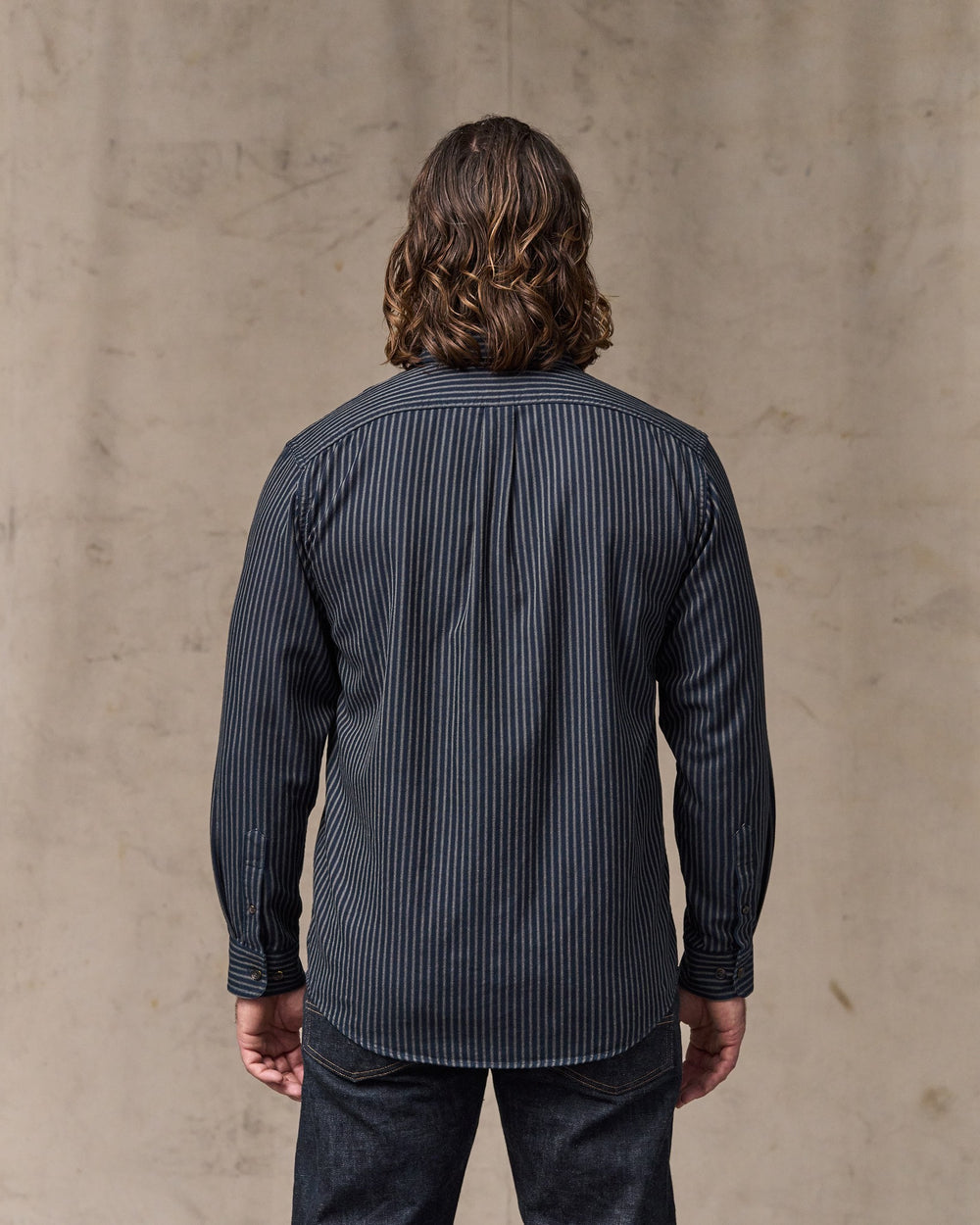 image of a model wearing Filson's Lightweight Alaskan Guide Shirt - Indigo / Ticking Stripe