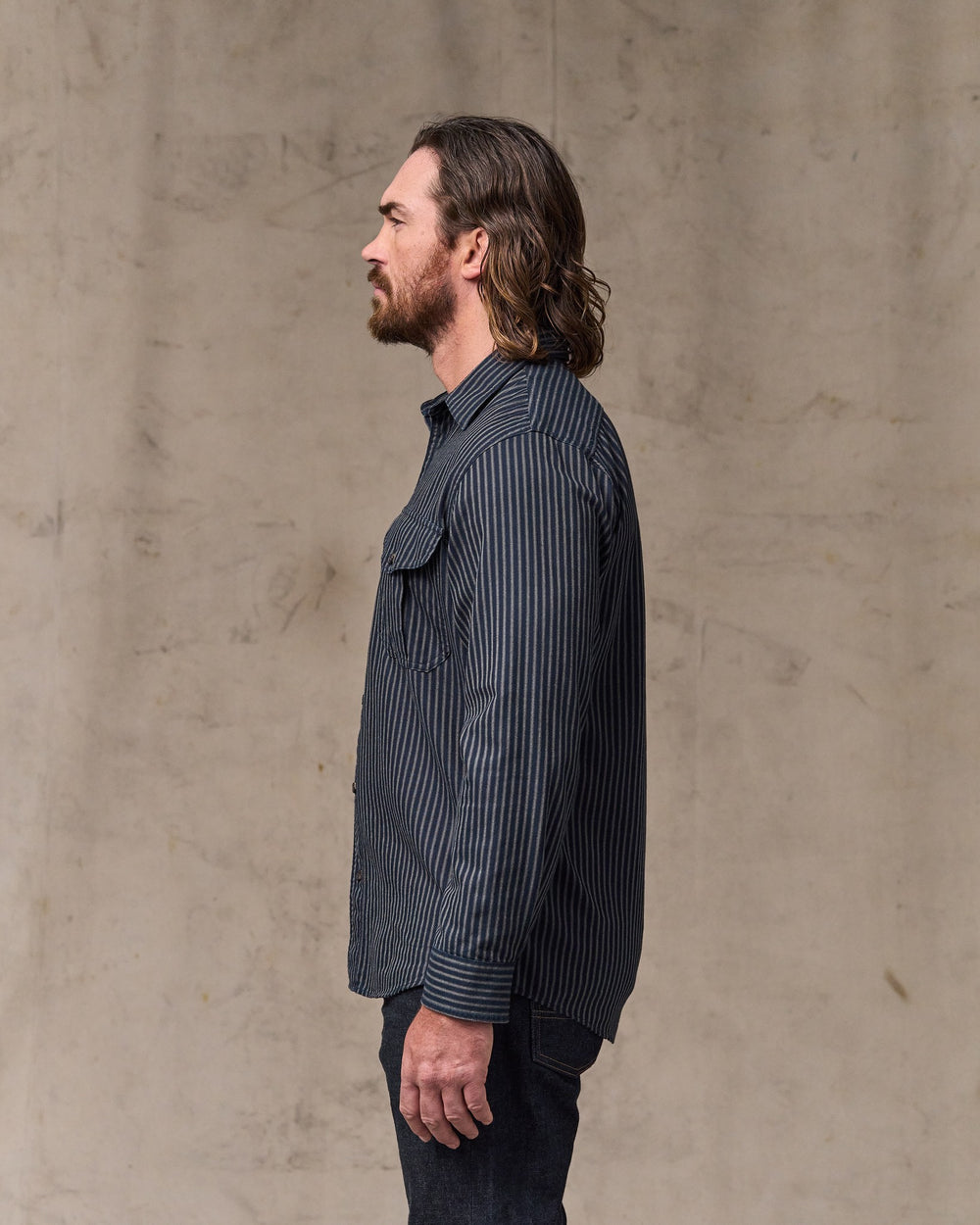 image of a model wearing Filson's Lightweight Alaskan Guide Shirt - Indigo / Ticking Stripe