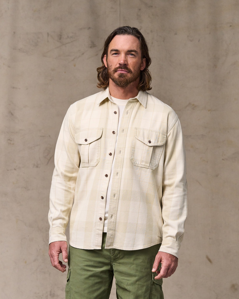image of a model wearing Filson's Vintage Wash Alaskan Guide Shirt - Sand / Stone Plaid