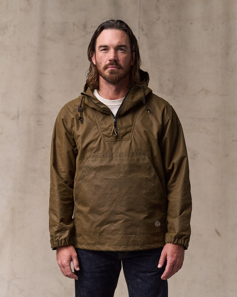 image of a model wearing Filson's Shelter Cloth Waxed Anorak - Dark Tan