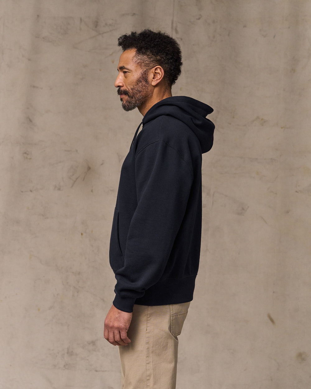 image of a model wearing Filson's 14-oz. Heritage Fleece Hoodie - Dark Indigo
