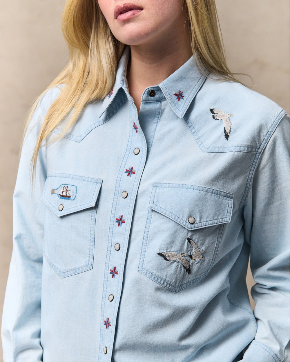 image of a model wearing Filson's Women's Embroidered Western Shirt - Light Indigo