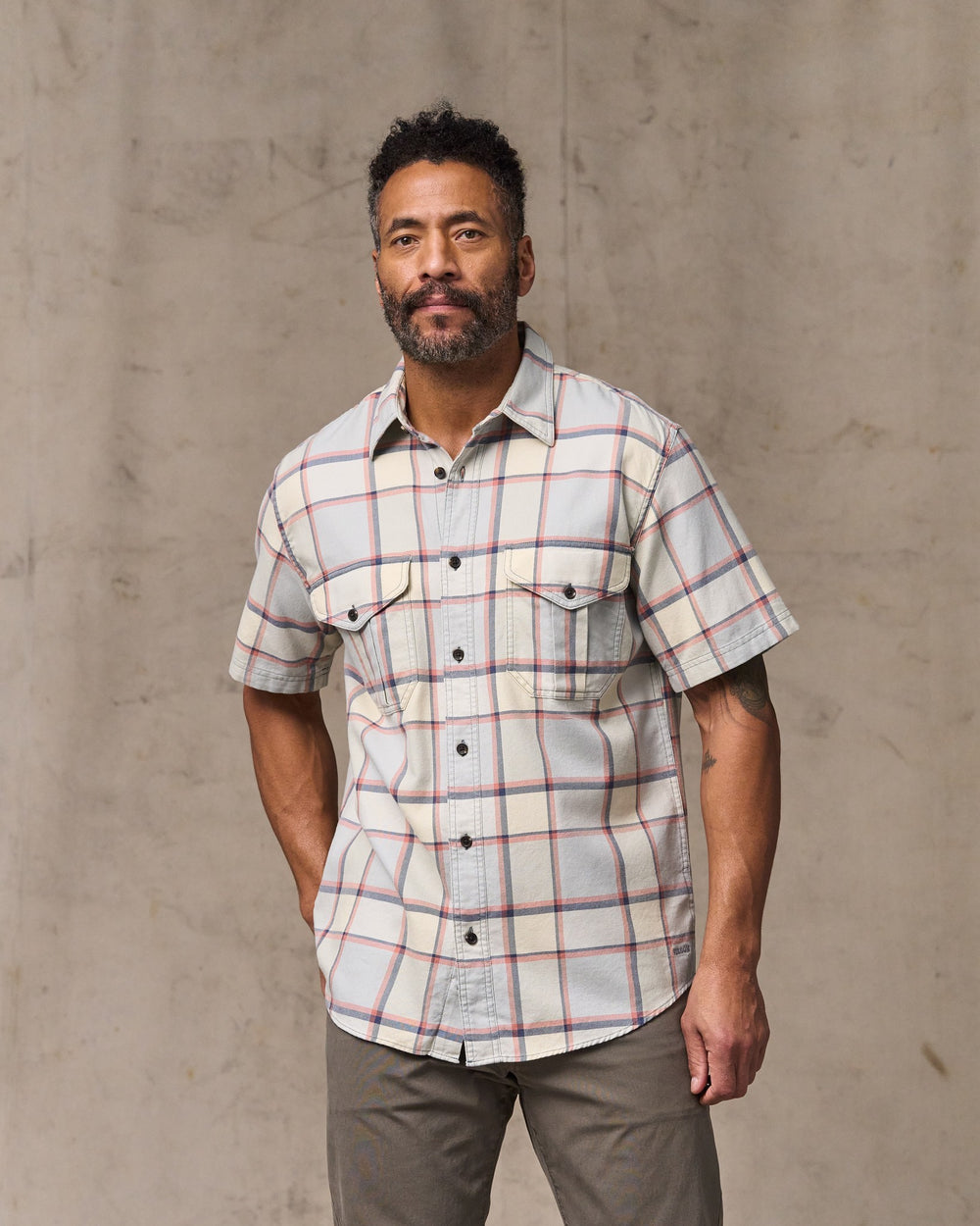 image of a model wearing Filson's Short Sleeve Lightweight Alaskan Guide Shirt  - Light Blue / Tan Plaid