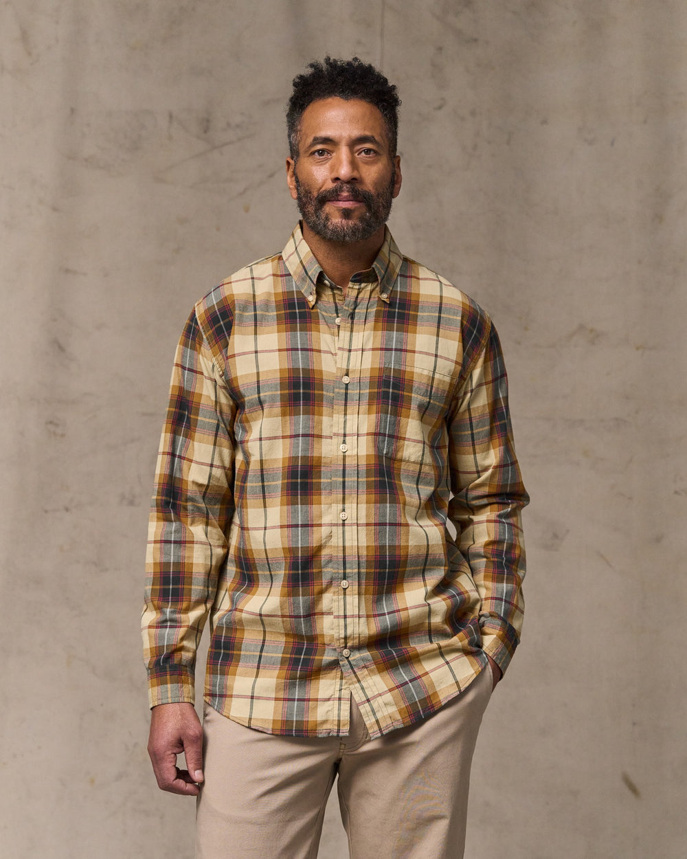 image of a model wearing Filson's Madras Button-down Shirt - Tan / Spruce Multi
