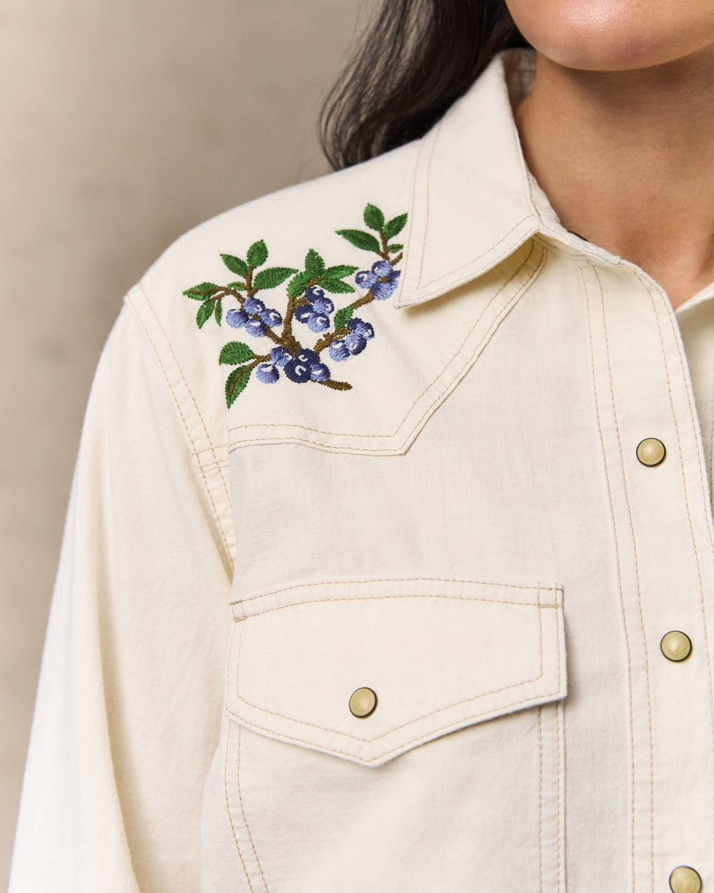 image of a model wearing Filson's Women's Embroidered Western Shirt - Natural Seed