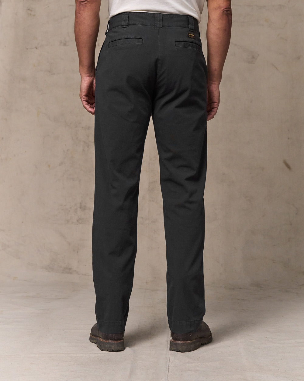 image of a model wearing Filson's Granite Mountain Flat Front Pants - Washed Faded Black