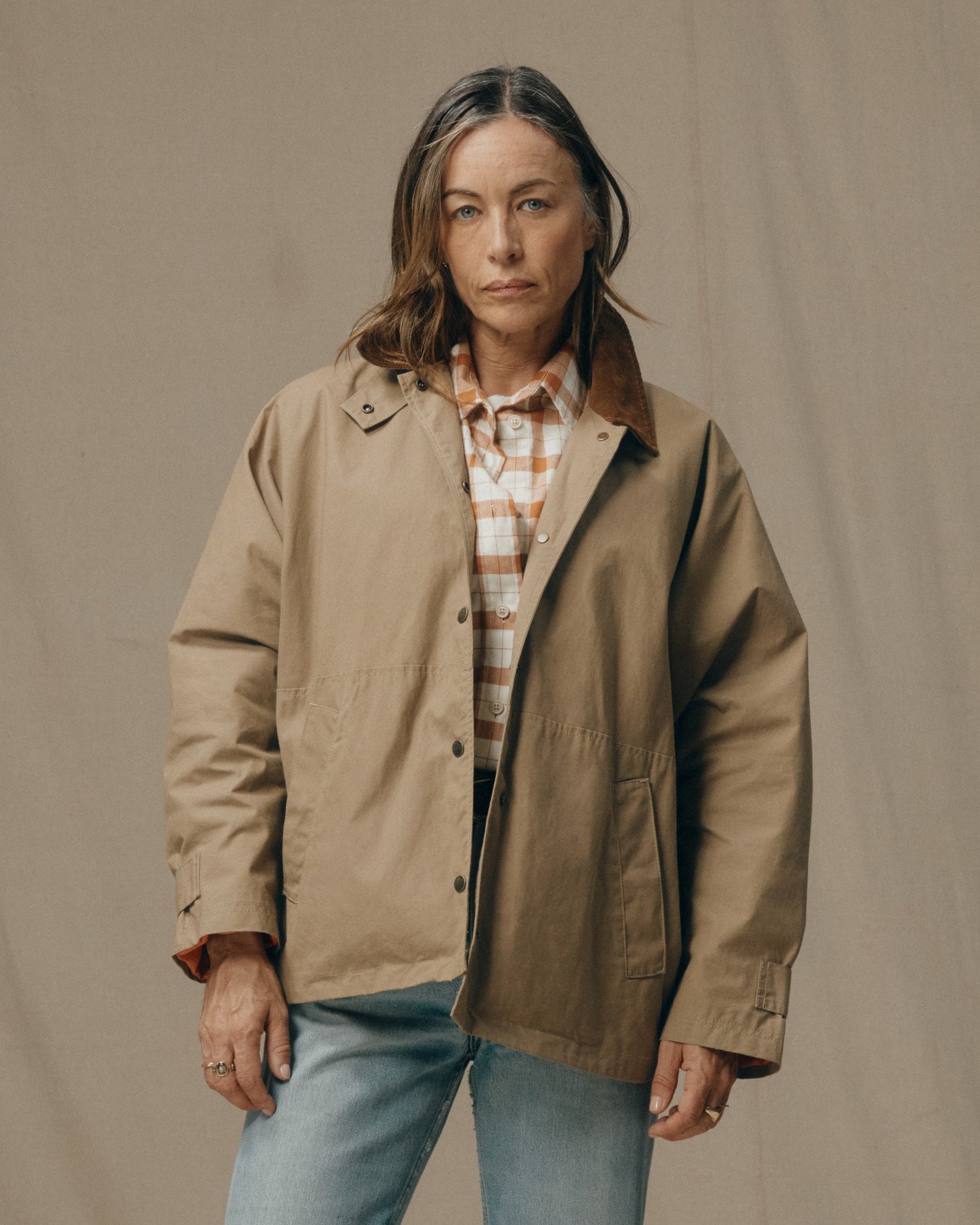 image of a model wearing Filson's Women's Harbor Front Waxed Jacket - Marsh Tan|Model is 5'8" wearing a size medium