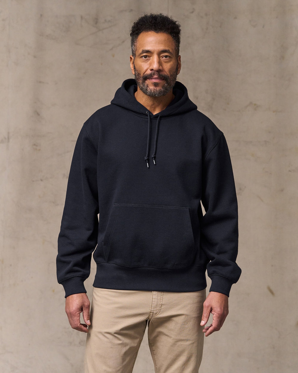 image of a model wearing Filson's 14-oz. Heritage Fleece Hoodie - Dark Indigo