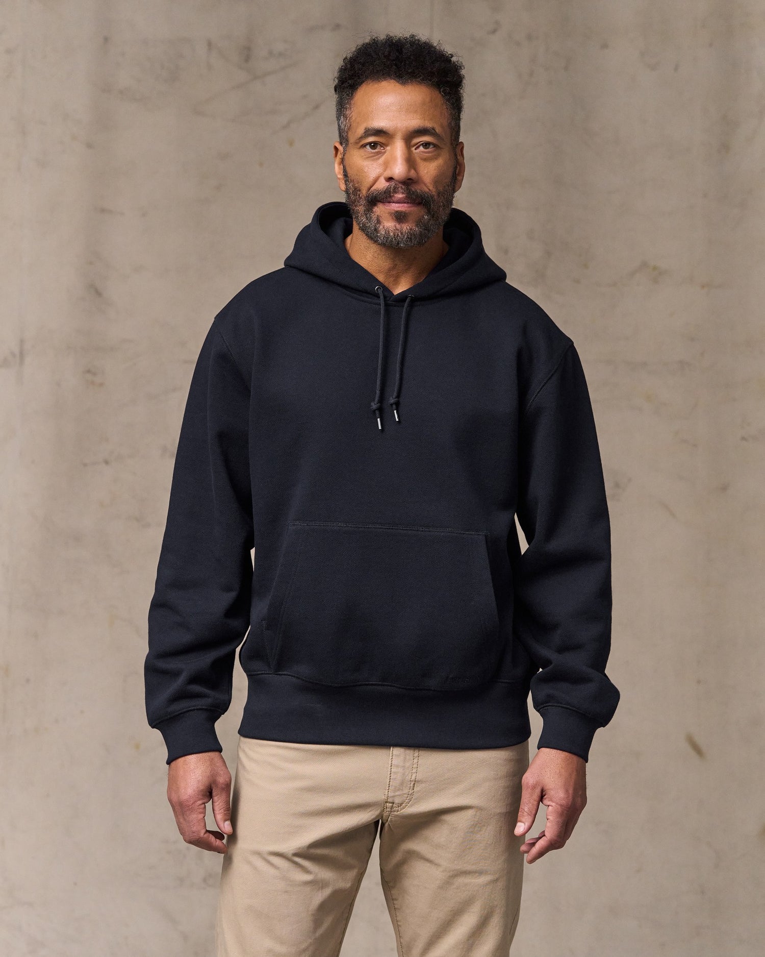 image of a model wearing Filson's 14-oz. Heritage Fleece Hoodie - Dark Indigo|Model is 6'2" wearing a size medium