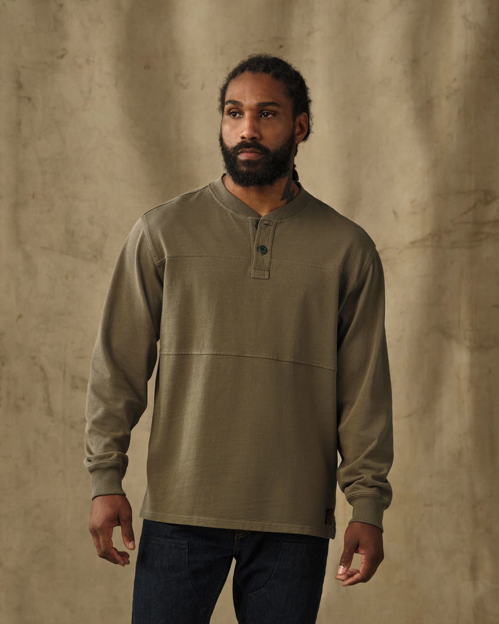 image of a model wearing Filson's Field Knit Henley - Military Olive