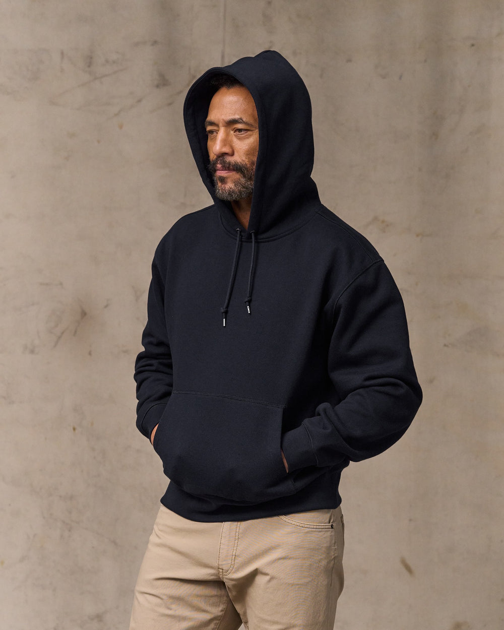 image of a model wearing Filson's 14-oz. Heritage Fleece Hoodie - Dark Indigo