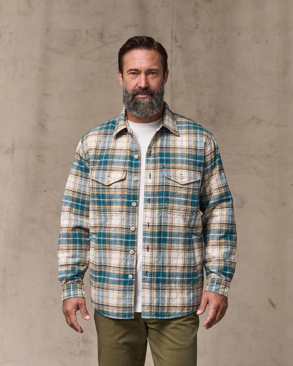 image of a model wearing Filson's Insulated Flannel Jac-shirt - Teal / Khaki Plaid