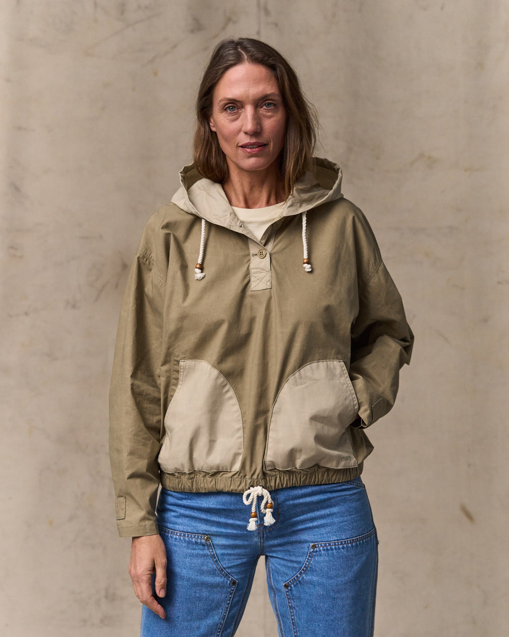 image of a model wearing Filson's Women's Dry Wax Hooded Popover - Khaki / Quail Tan