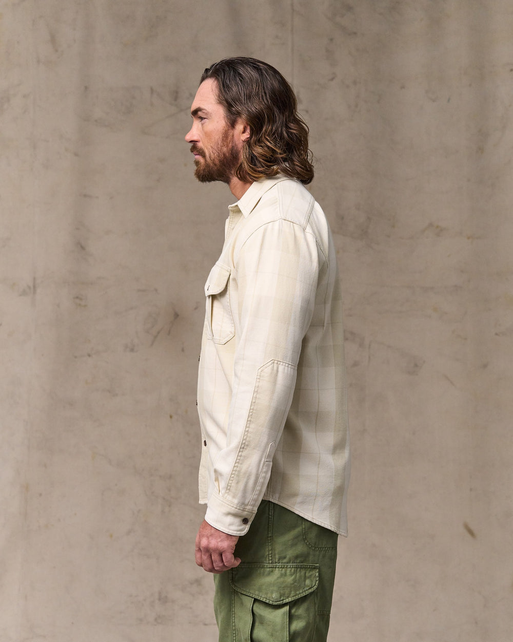image of a model wearing Filson's Vintage Wash Alaskan Guide Shirt - Sand / Stone Plaid