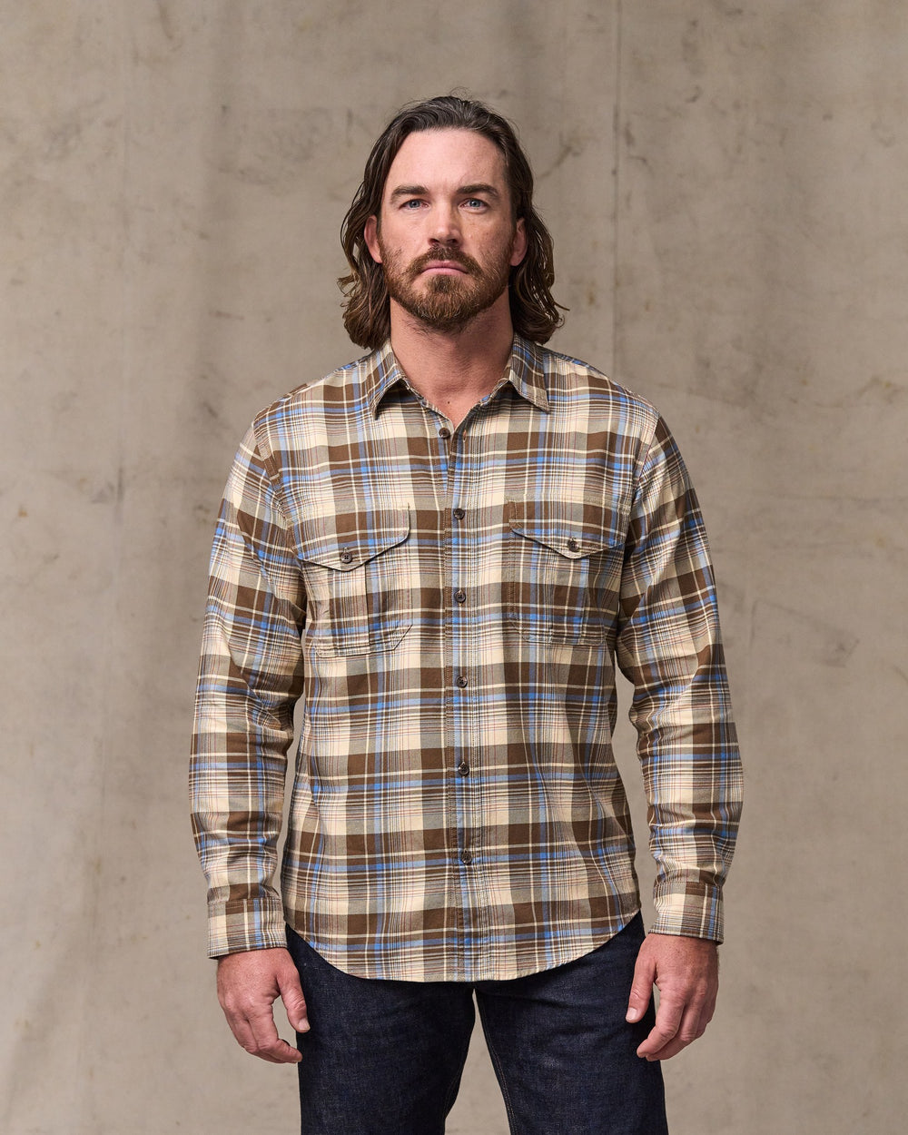image of a model wearing Filson's Lightweight Alaskan Guide Shirt - Cream / Blue / Multi Plaid