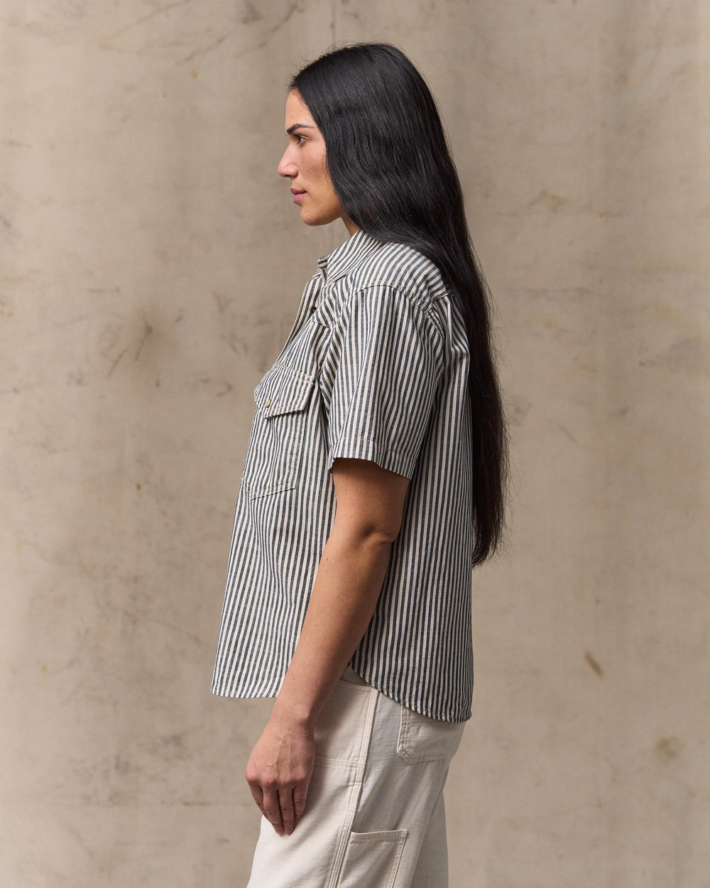 image of a model wearing Filson's Women's Short Sleeve Chambray Western Shirt - Indigo / Natural