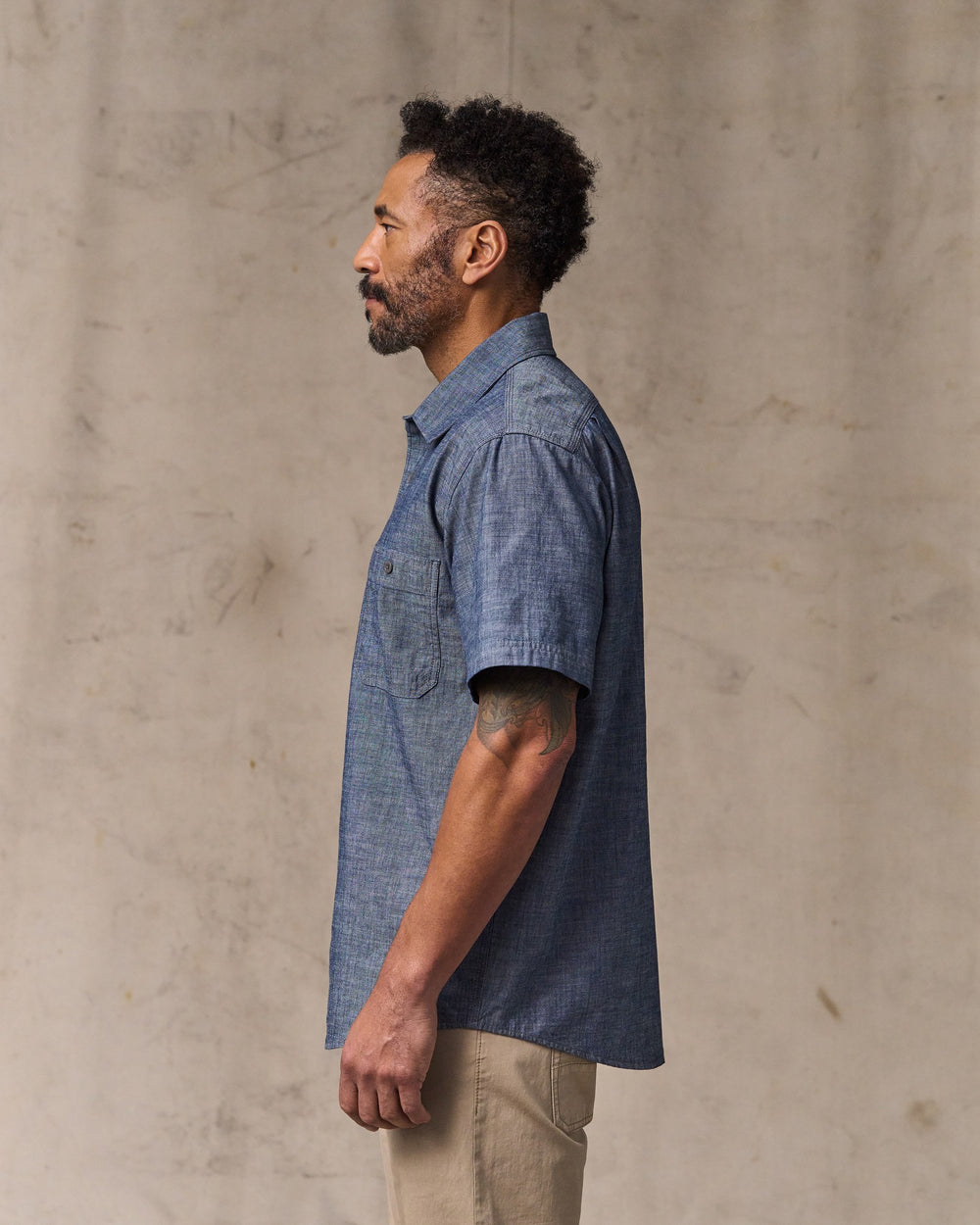 image of a model wearing Filson's Short Sleeve Chambray Shirt  - Vintage Fade