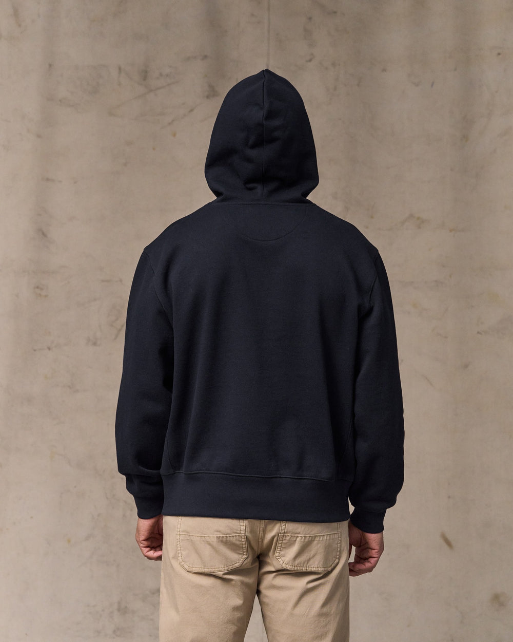image of a model wearing Filson's 14-oz. Heritage Fleece Hoodie - Dark Indigo