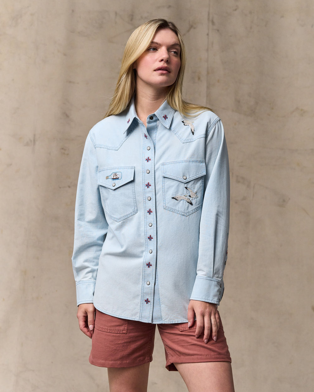 image of a model wearing Filson's Women's Embroidered Western Shirt - Light Indigo