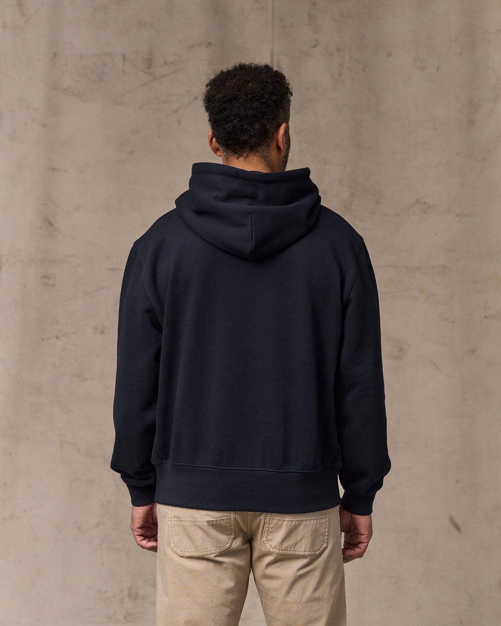 image of a model wearing Filson's 14-oz. Heritage Fleece Hoodie - Dark Indigo