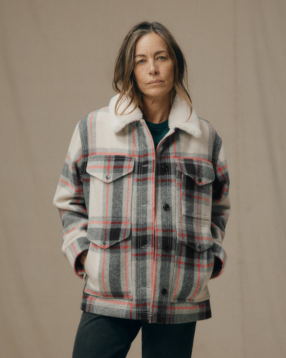 image of a model wearing Filson's Women's Mackinaw Wool Shearling Cruiser Jacket - Cream / Red / Black Plaid