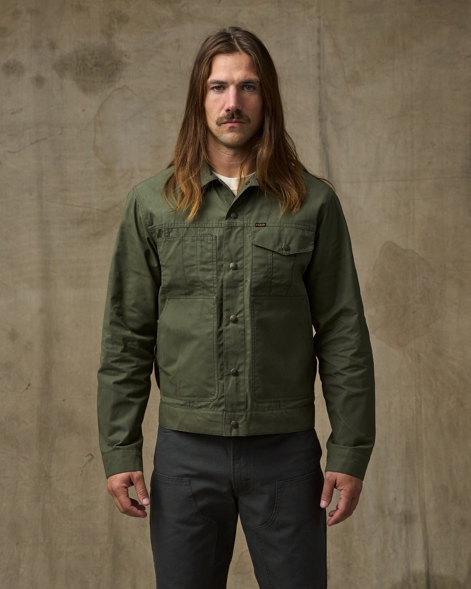 image of a model wearing Filson's Dry Wax Short Cruiser Jacket - Olive|| Model is 5'10" wearing a size medium
