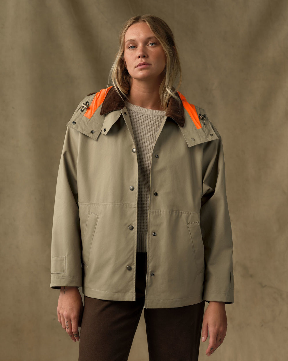 image of a model wearing Filson's Women's Harbor Front Waxed Jacket - Marsh Tan