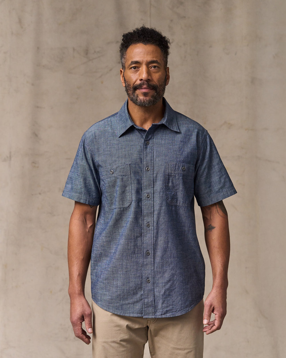 image of a model wearing Filson's Short Sleeve Chambray Shirt  - Vintage Fade