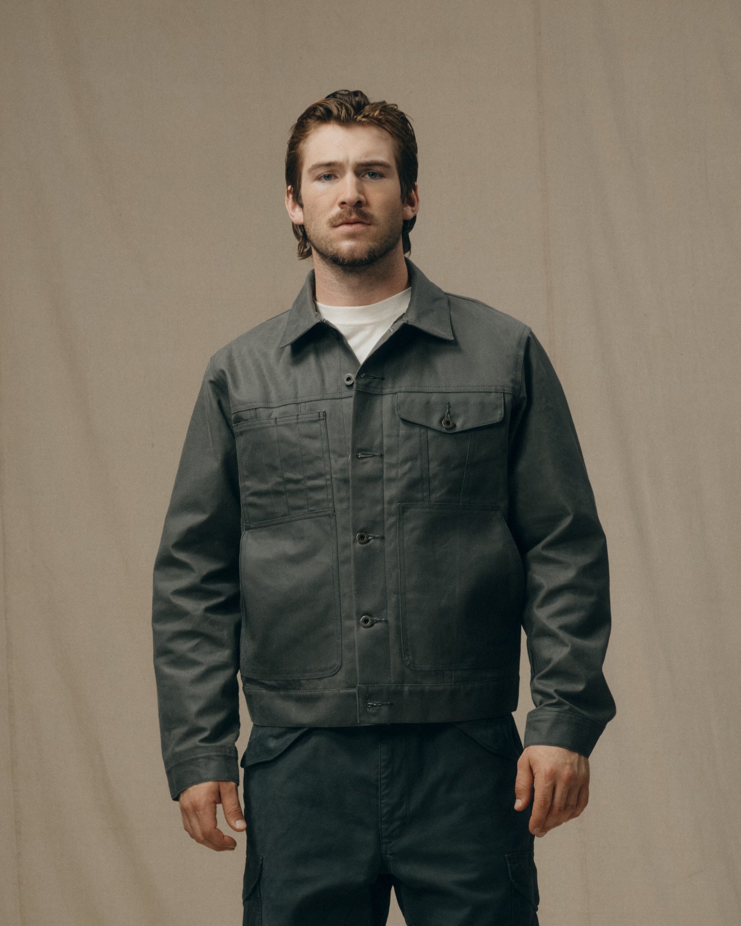 image of a model wearing Filson's Tin Cloth Short Lined Cruiser Jacket - Castor Gray|Model is 6' wearing a size medium
