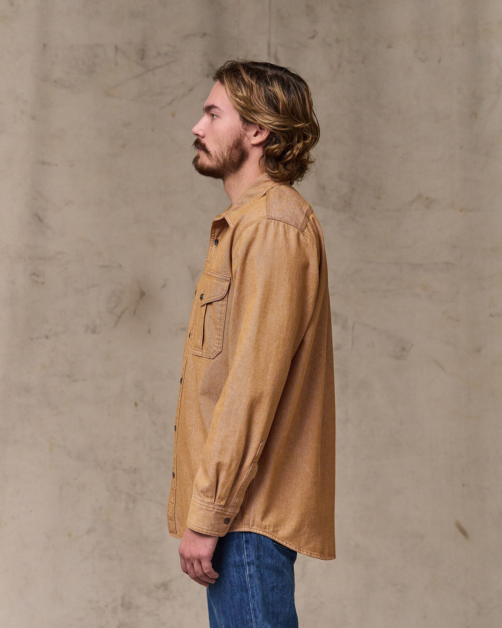 image of a model wearing Filson's Denim Guide Shirt - Harvest Tan