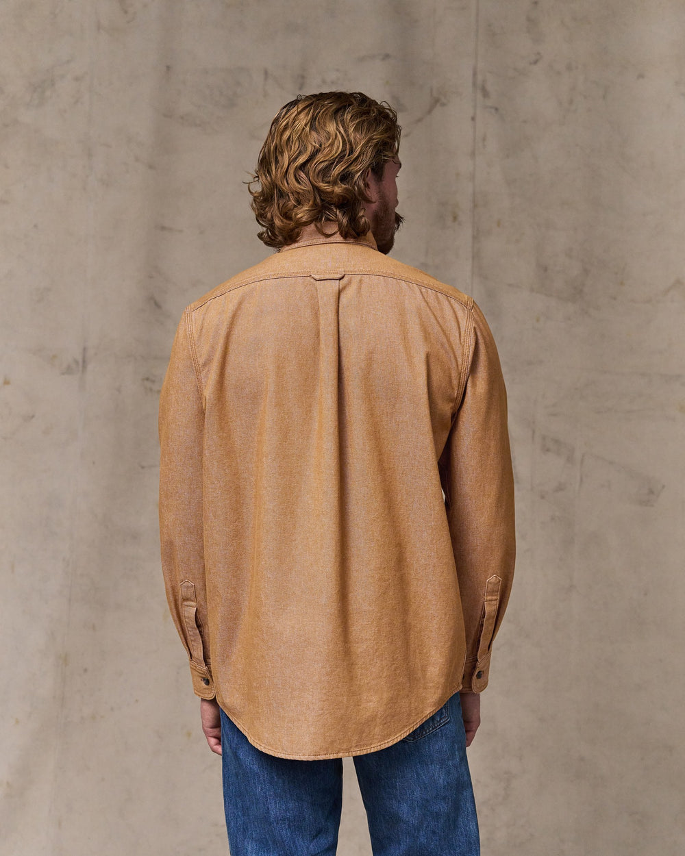 image of a model wearing Filson's Denim Guide Shirt - Harvest Tan