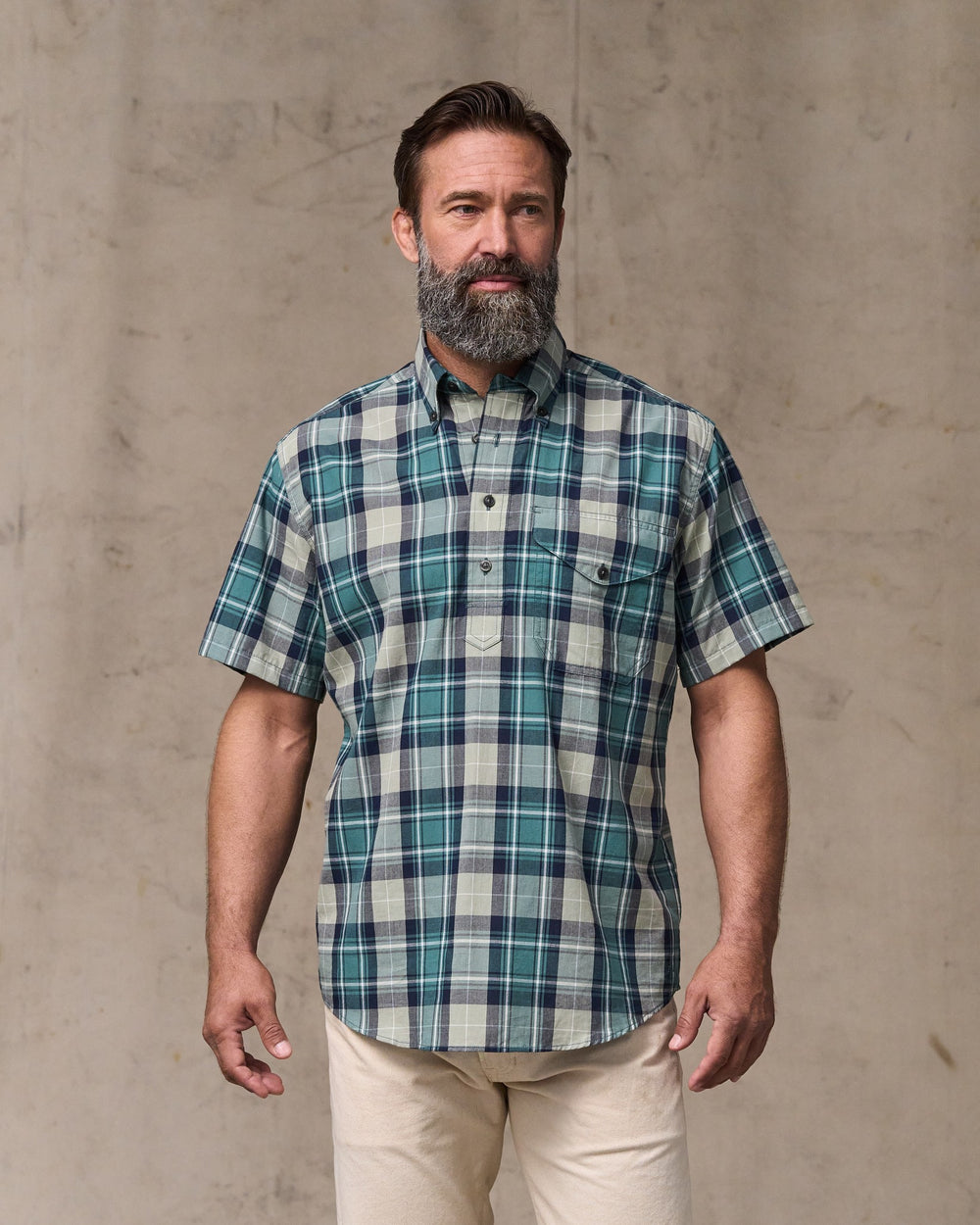 image of a model wearing Filson's Short Sleeve Madras Popover Shirt - Gray / Teal Multi