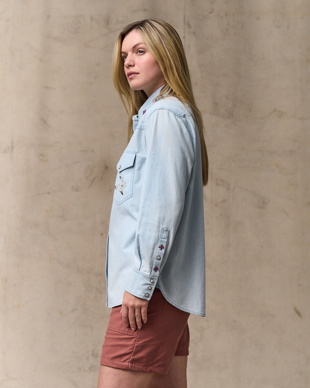 image of a model wearing Filson's Women's Embroidered Western Shirt - Light Indigo