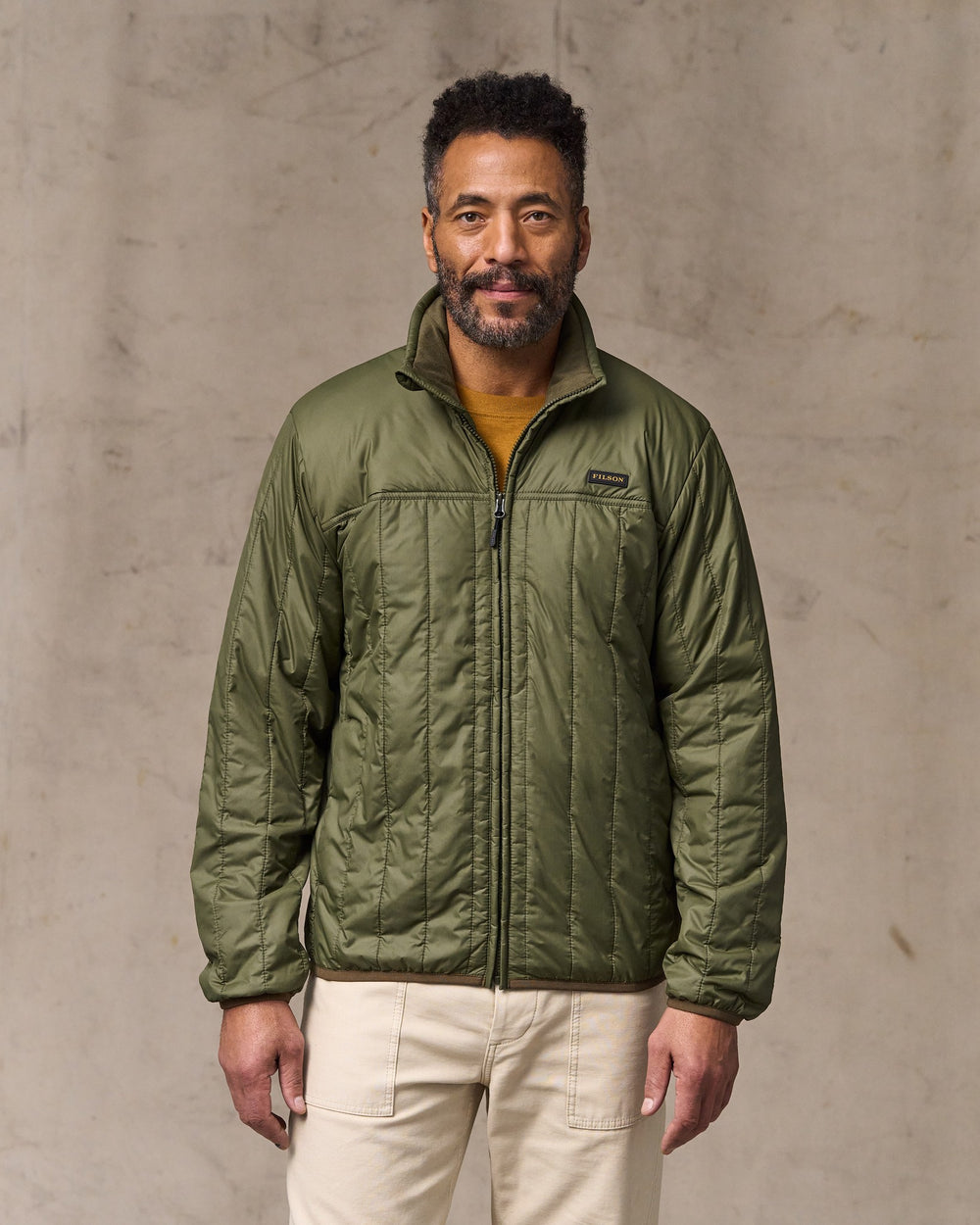 image of a model wearing Filson's Ultralight Jacket - Dark Olive Drab