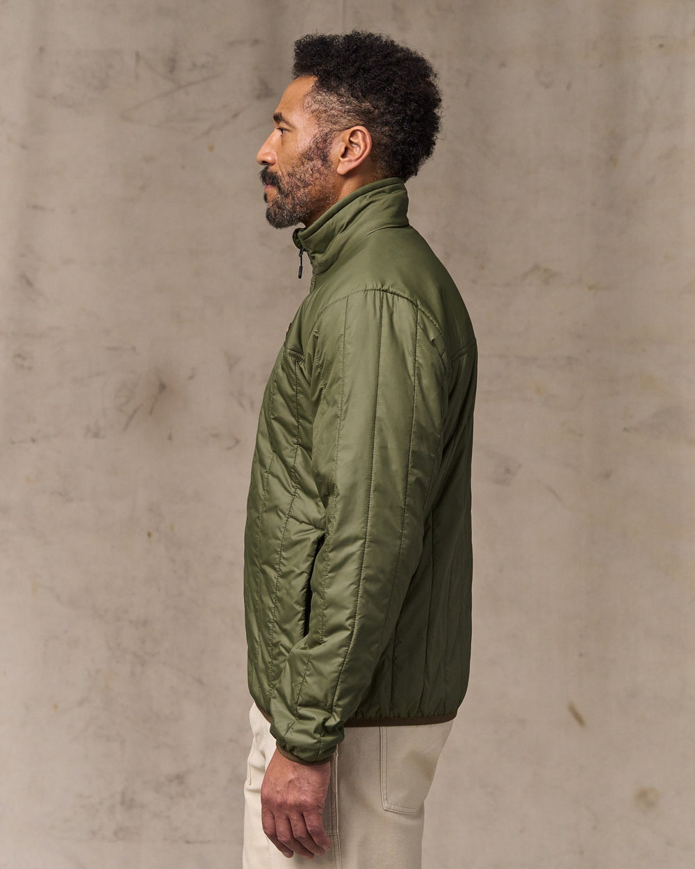 image of a model wearing Filson's Ultralight Jacket - Dark Olive Drab